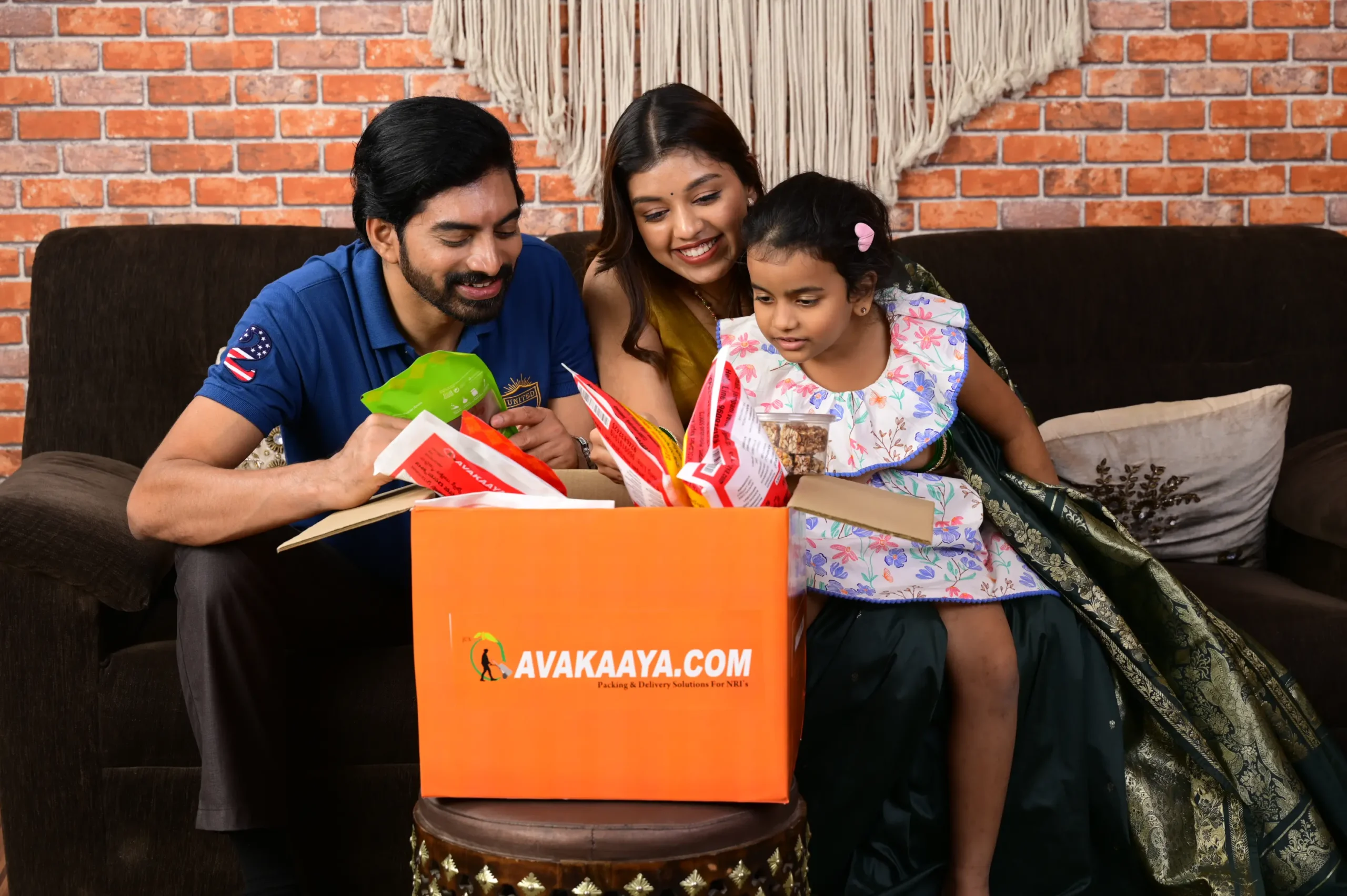 Happy family unboxing AVAKAAYA.COM package at home, highlighting trusted courier and parcel services for safe, timely delivery.