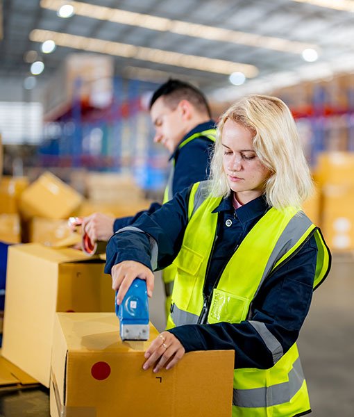 Warehouse staff sealing boxes efficiently, ensuring fast and reliable delivery with trusted Express courier services worldwide.
