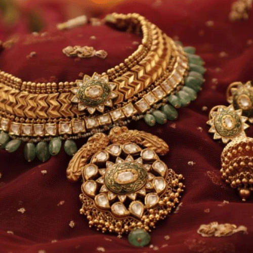Traditional gold jewelry set on red fabric, delivered securely by a trusted logistics company offering fast courier services.